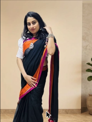 Model draped in a black and orange silk saree
